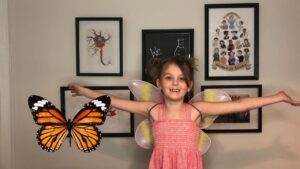 Butterflies and Metamorphosis young girl wearing butterfly wings next to a detailed image of a monarch butterfly