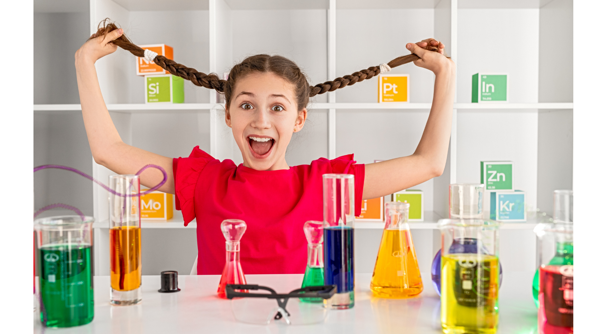 chemistry activities girl holding out her braided pigtails in a chemistry lab with a surprised look on her face