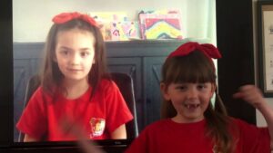 Two little girls wearing red headbands