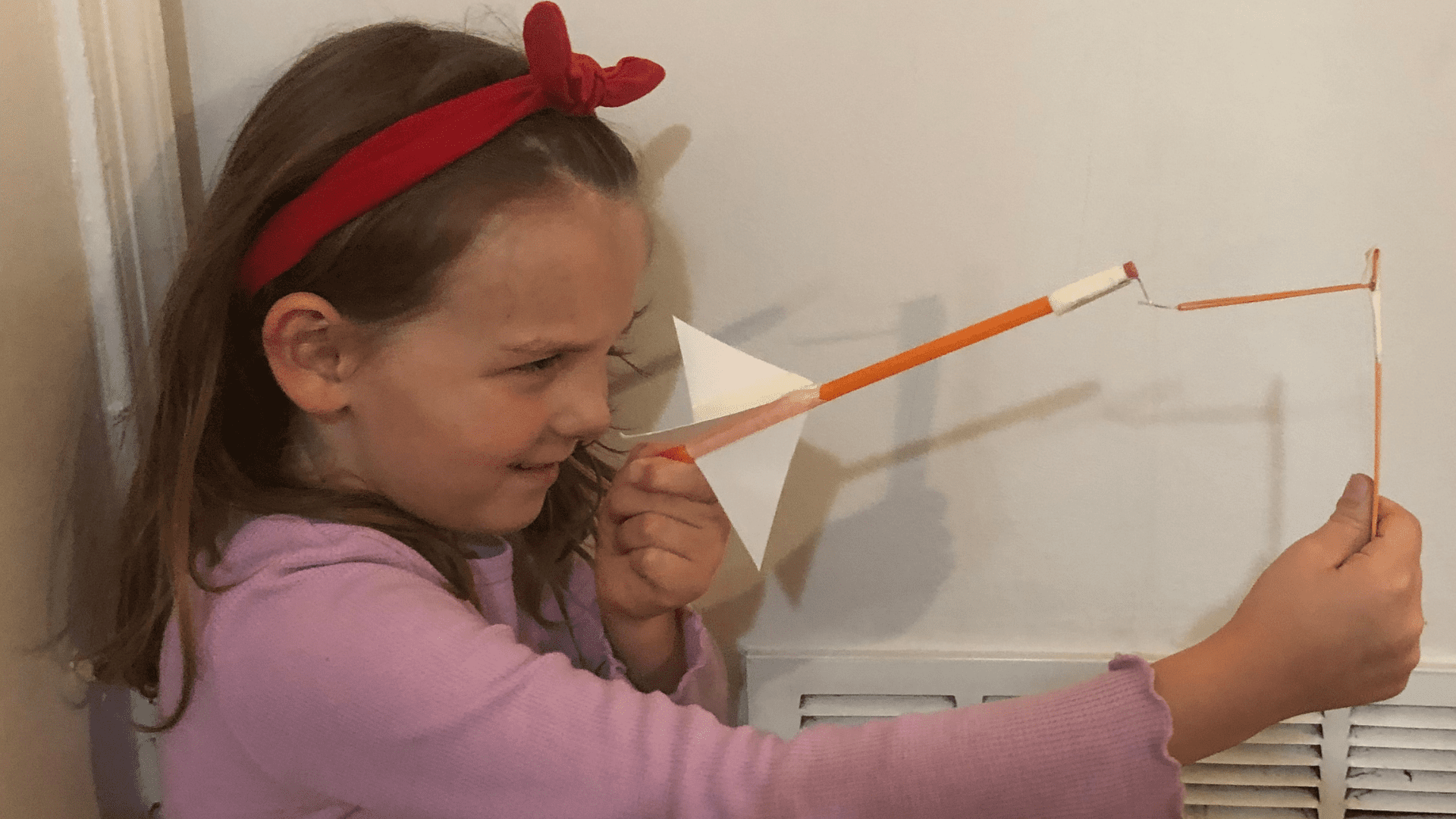 Slingshot Rockets Girl with a red bow aiming her homemade slingshot rocket